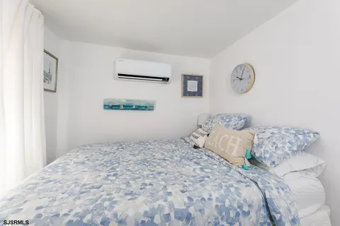 a bedroom with a large bed and a window