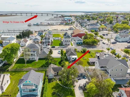 an aerial view of residential houses with outdoor space and swimming pool