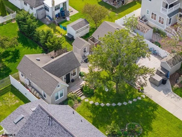 an aerial view of multiple houses with yard