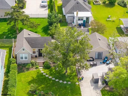 an aerial view of a house with a yard and garden
