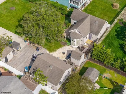an aerial view of residential houses with outdoor space and street view