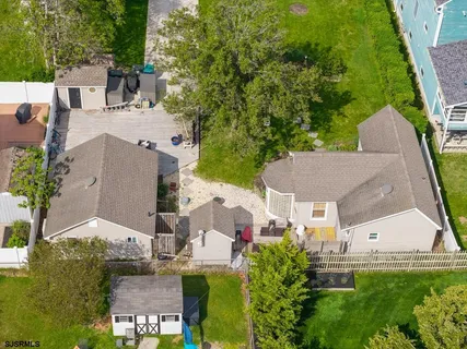 an aerial view of a house with a garden and swimming pool
