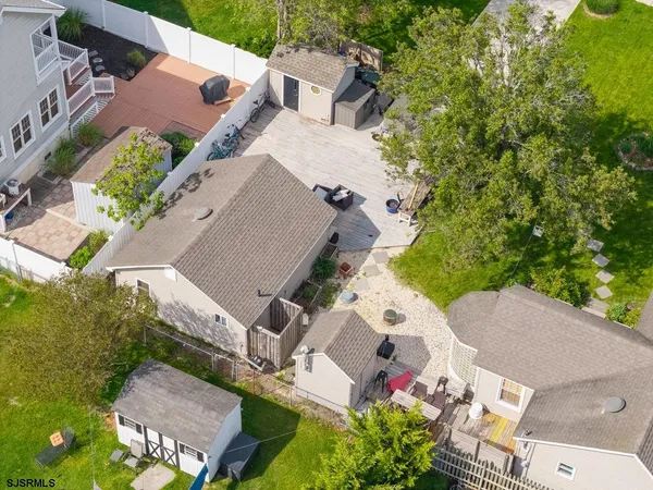 an aerial view of a house with a garden and lake view