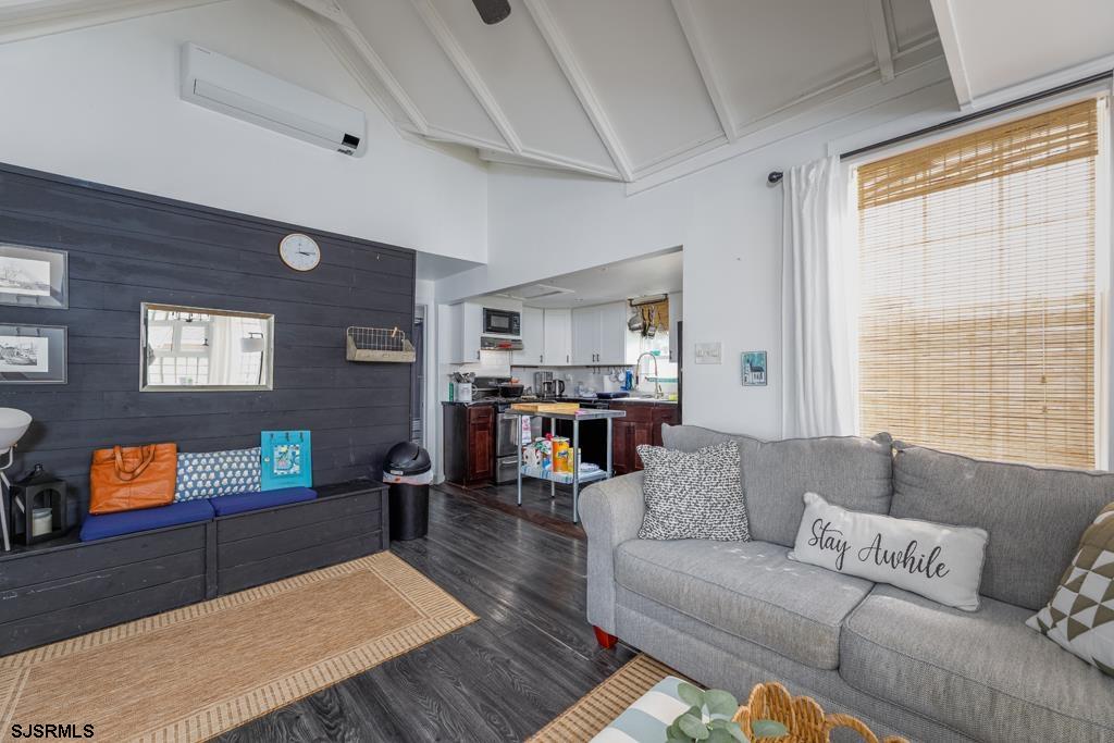 100 Decatur Avenue Somers Point, NJ 08244 - Photo 5 of 52 a living room with furniture and a flat screen tv next to a window
