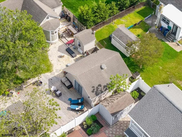 an aerial view of a house with a yard and trees