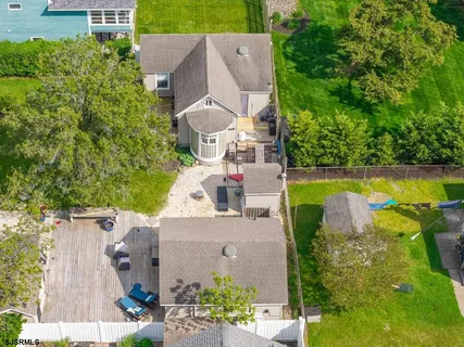 an aerial view of a house with outdoor space and a lake view