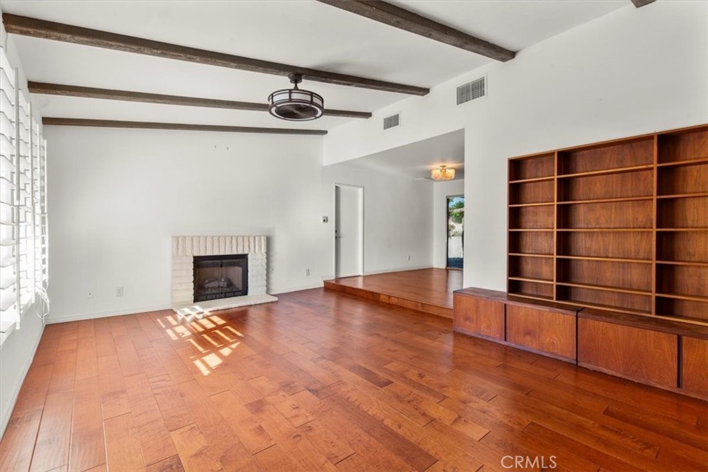 2250 Tamarisk Road Palm Springs, CA 92262 - Photo 12 of 36 a view of an empty room with a fireplace and a window