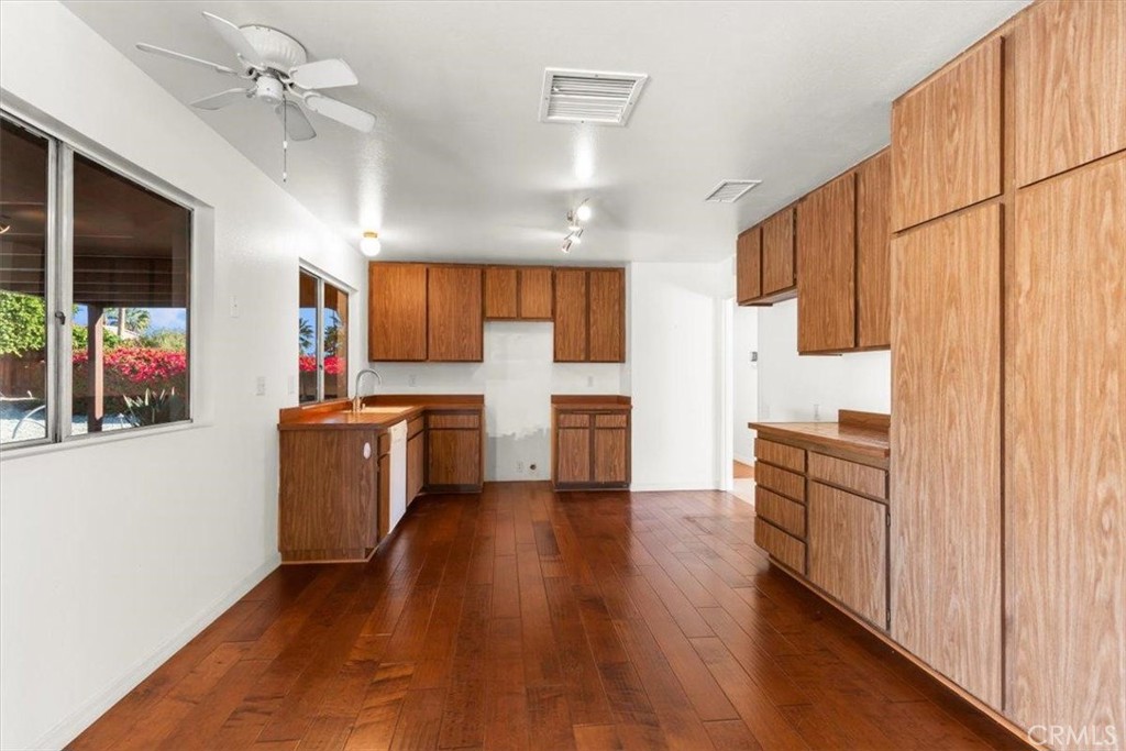 2250 Tamarisk Road Palm Springs, CA 92262 - Photo 17 of 36 a kitchen with stainless steel appliances a refrigerator sink and cabinets
