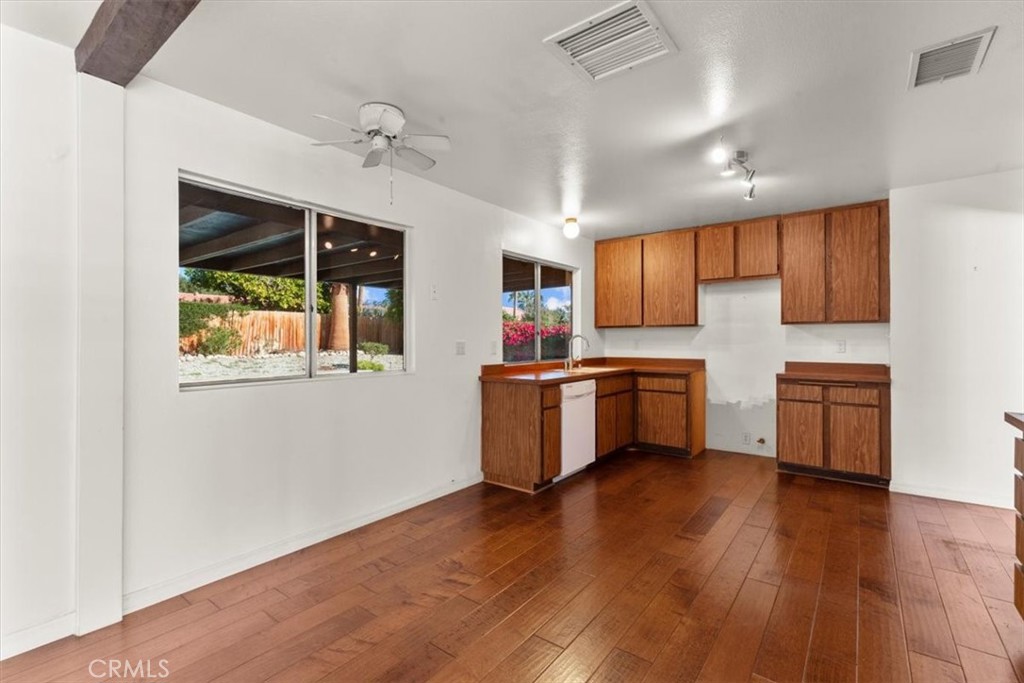 2250 Tamarisk Road Palm Springs, CA 92262 - Photo 21 of 36 a kitchen with stainless steel appliances a white cabinets and wooden floors