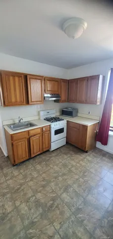 a kitchen with stainless steel appliances a stove a sink and a refrigerator