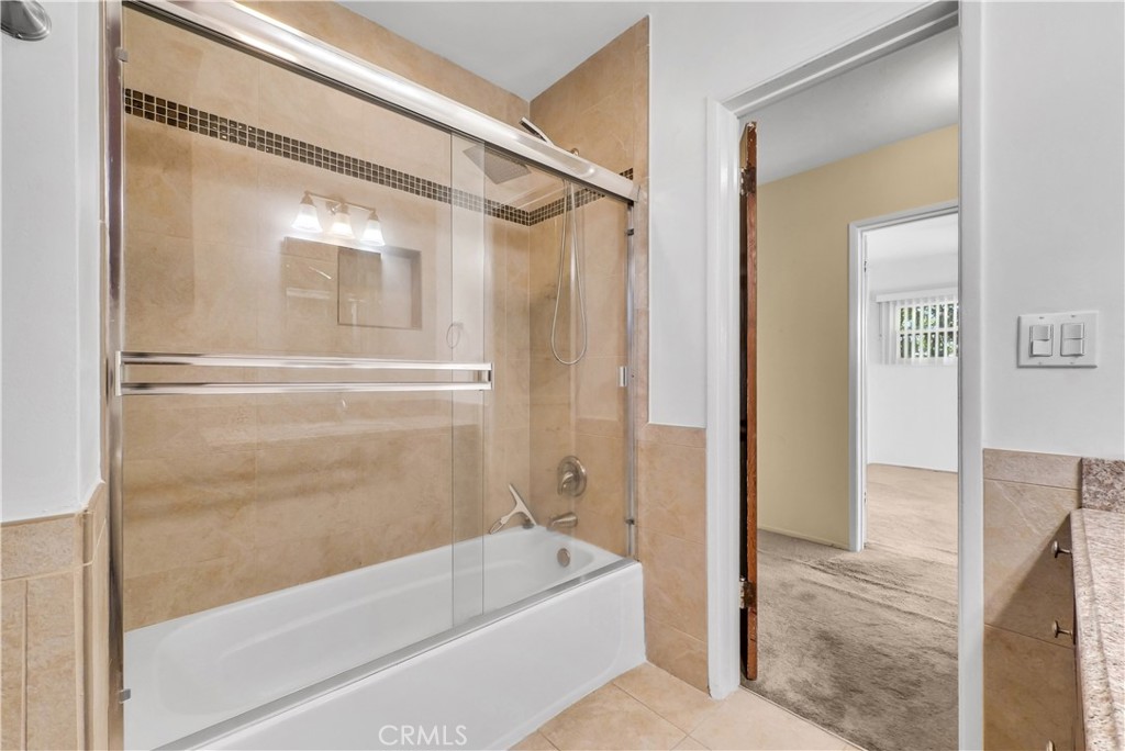 3921 Heidi Road Riverside, CA 92504 - Photo 12 of 20 a bathroom with a tub shower and sink