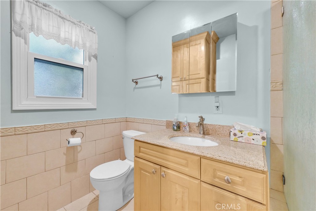 3921 Heidi Road Riverside, CA 92504 - Photo 15 of 20 a bathroom with a sink toilet and mirror