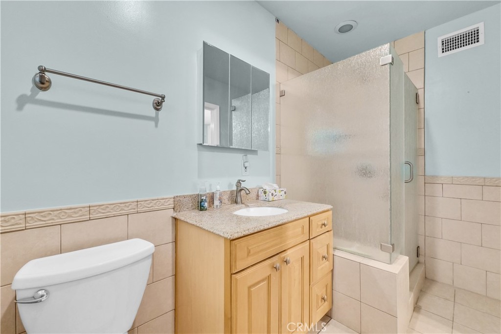 3921 Heidi Road Riverside, CA 92504 - Photo 16 of 20 a bathroom with a sink a toilet and shower