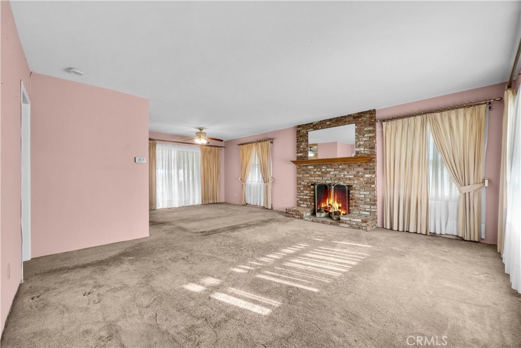 3921 Heidi Road Riverside, CA 92504 - Photo 3 of 20 a view of a livingroom with an empty space and a fireplace