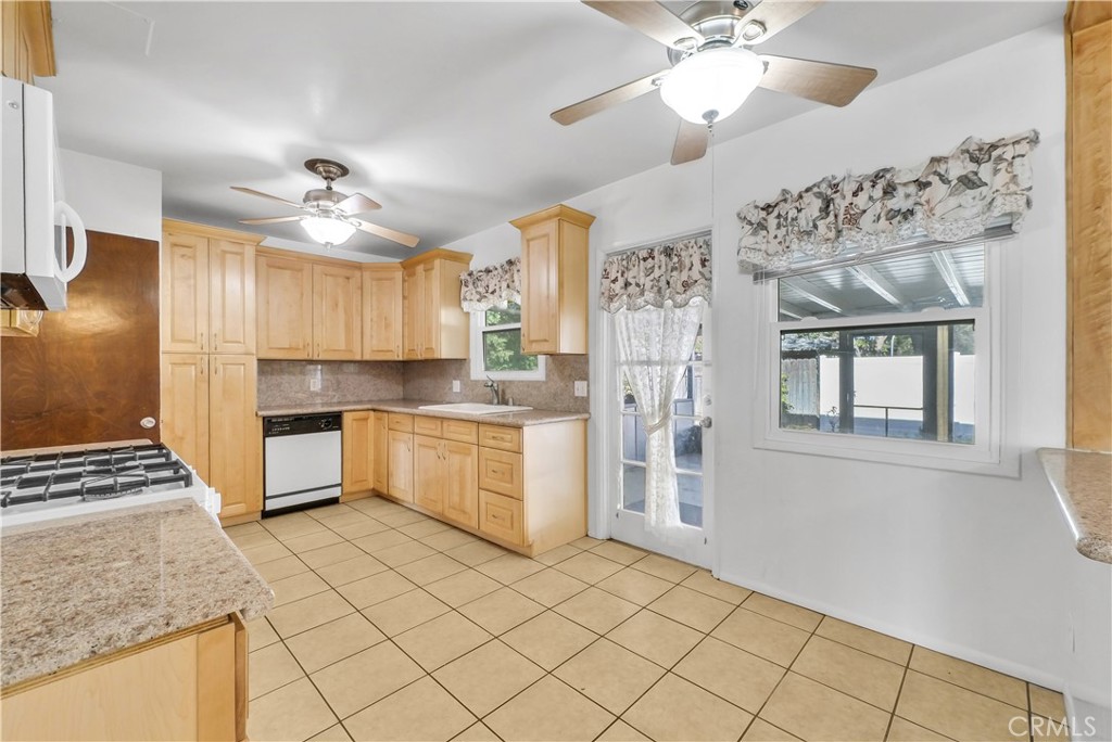 3921 Heidi Road Riverside, CA 92504 - Photo 7 of 20 a large kitchen with cabinets and stainless steel appliances