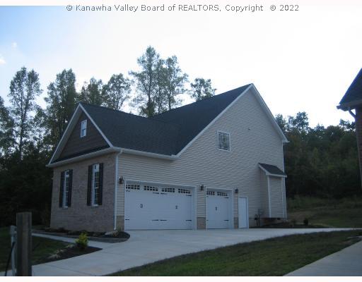 Exterior Front. 3-car side load garage.  Designer carriage style doors!
