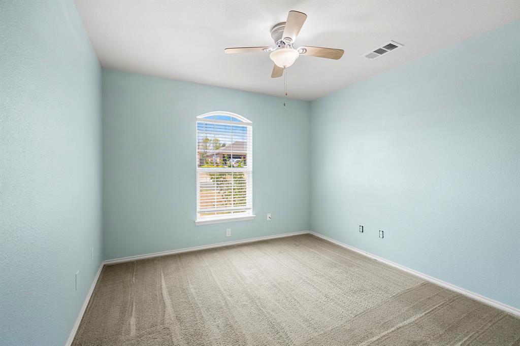 10620 Granada Drive Waco, TX 76708 - Photo 25 of 38 Arched window with blinds, ceiling fan, and light blue wall finish