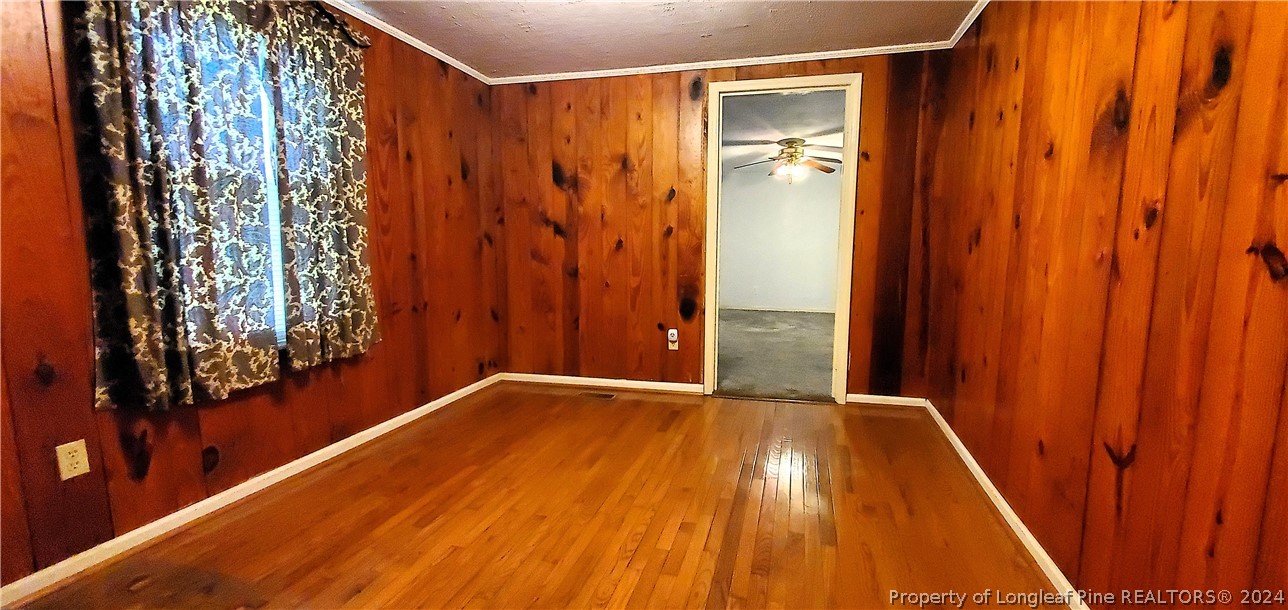7780 Howell Road Lumberton, NC 28358 - Photo 16 of 27 a view of a room with wooden floor and a curtain