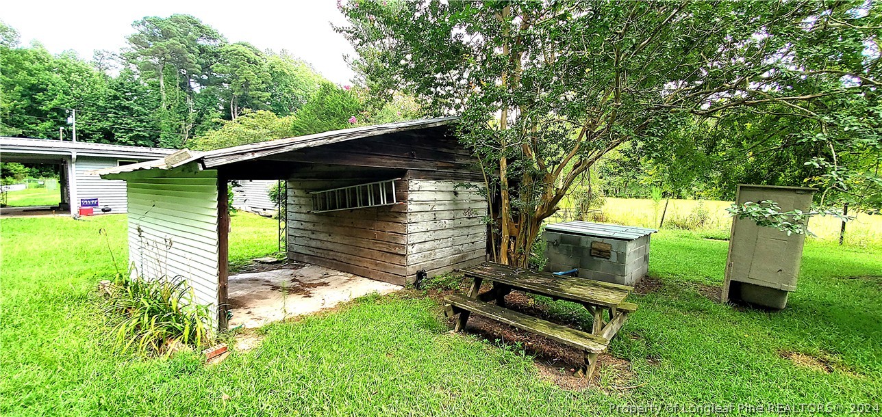 7780 Howell Road Lumberton, NC 28358 - Photo 23 of 27 a backyard of a house with table and chairs
