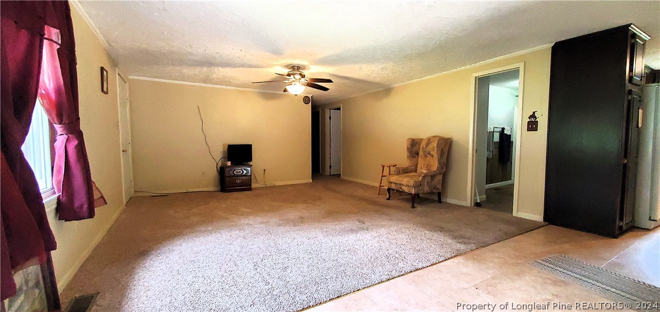 7780 Howell Road Lumberton, NC 28358 - Photo 8 of 27 a view of a room with gym equipment and a chandelier