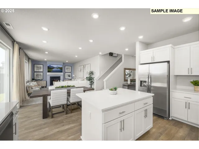 a kitchen with a table chairs and a refrigerator