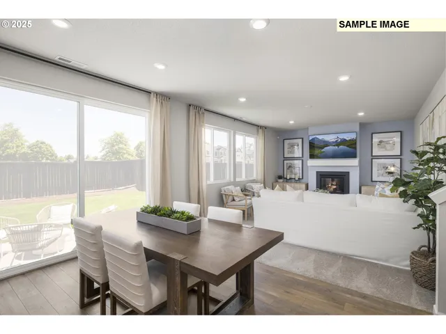 a living room with furniture a large window and a fireplace