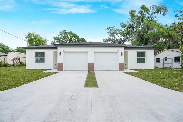 a view of a house with a yard and garage