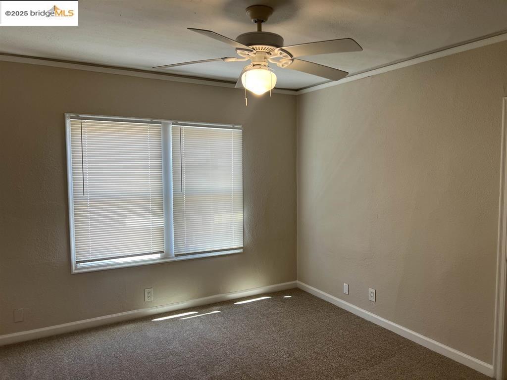 449 East 9th Street Pittsburg, CA 94565 - Photo 11 of 17 an empty room with windows and fan