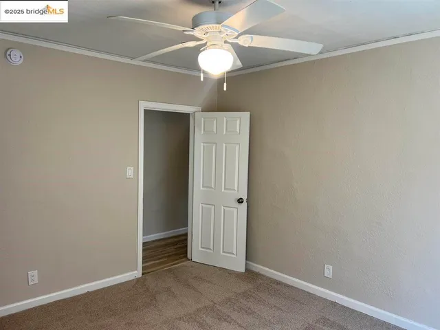 a white toilet sitting in a bathroom next to a window