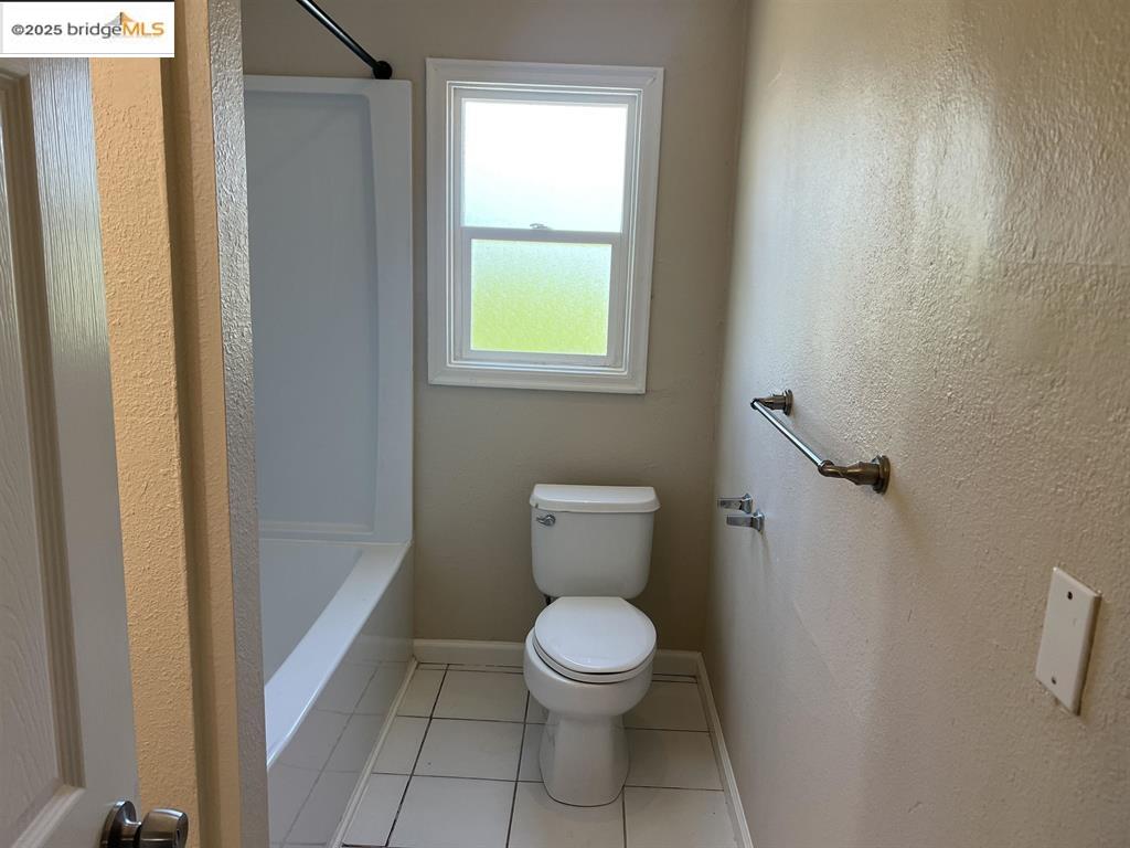 449 East 9th Street Pittsburg, CA 94565 - Photo 13 of 17 a white toilet sitting in a bathroom next to a window