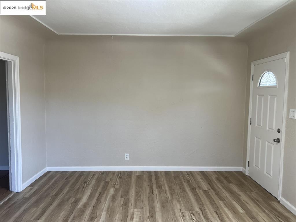 449 East 9th Street Pittsburg, CA 94565 - Photo 3 of 17 a view of an empty room and wooden floor