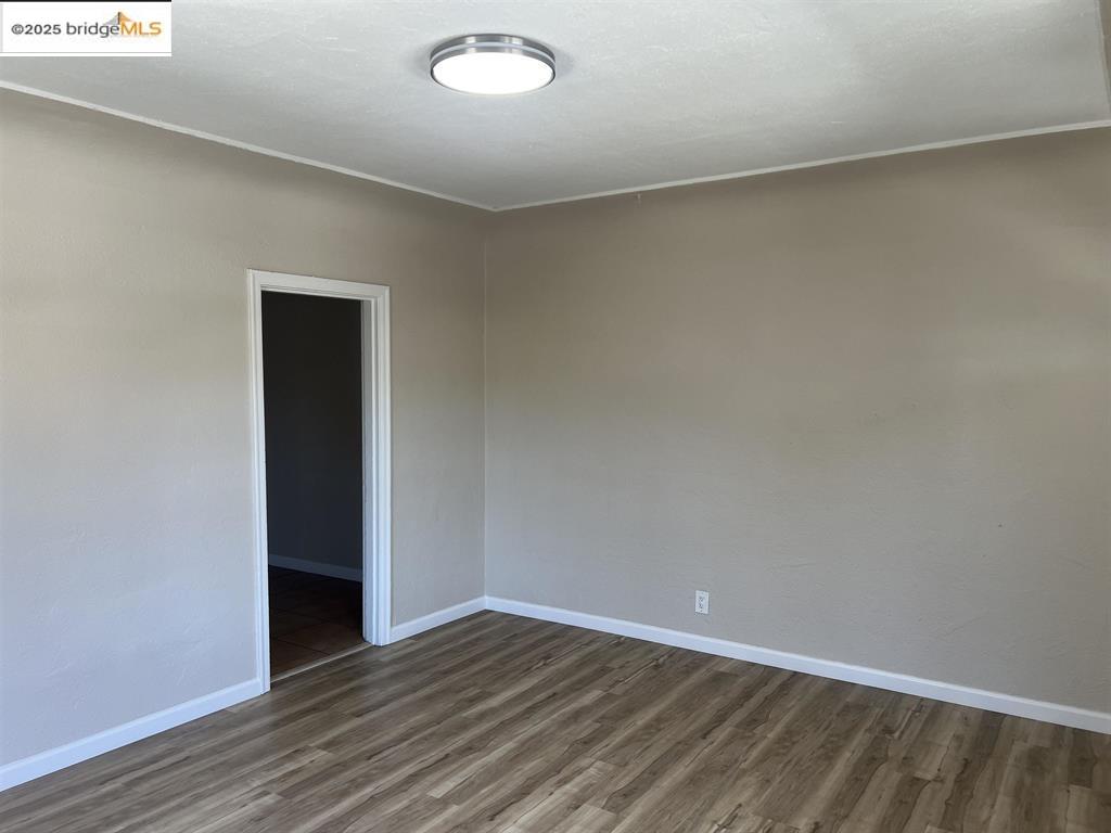 449 East 9th Street Pittsburg, CA 94565 - Photo 5 of 17 a view of an empty room with wooden floor