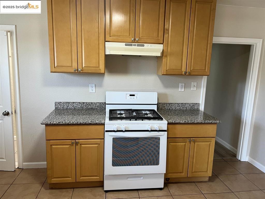 449 East 9th Street Pittsburg, CA 94565 - Photo 7 of 17 a kitchen with granite countertop cabinets stainless steel appliances and a counter space