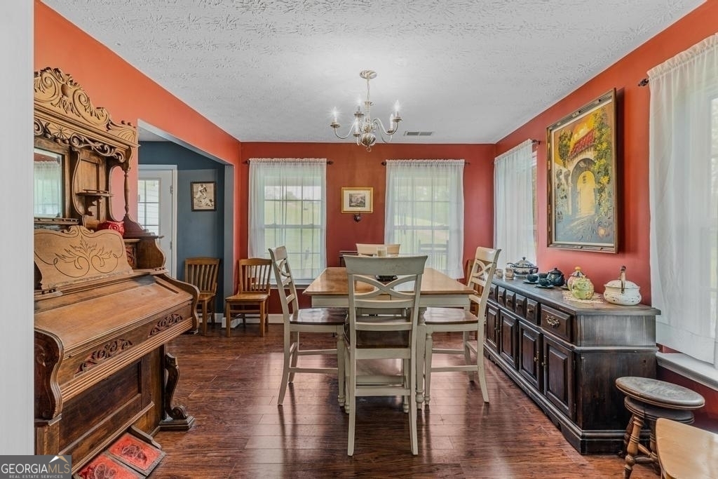 80 Upper Caldwell Road Bowdon, GA 30108 - Photo 11 of 33 a view of a dining room with furniture window and wooden floor