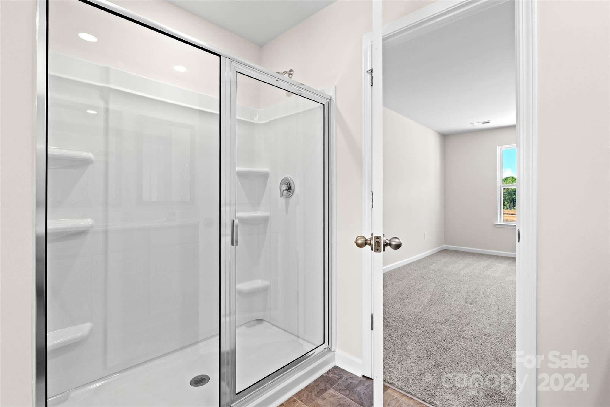 100 Callie River Clyde, NC 28721 - Photo 16 of 22 a bathroom with a glass shower door and a glass door