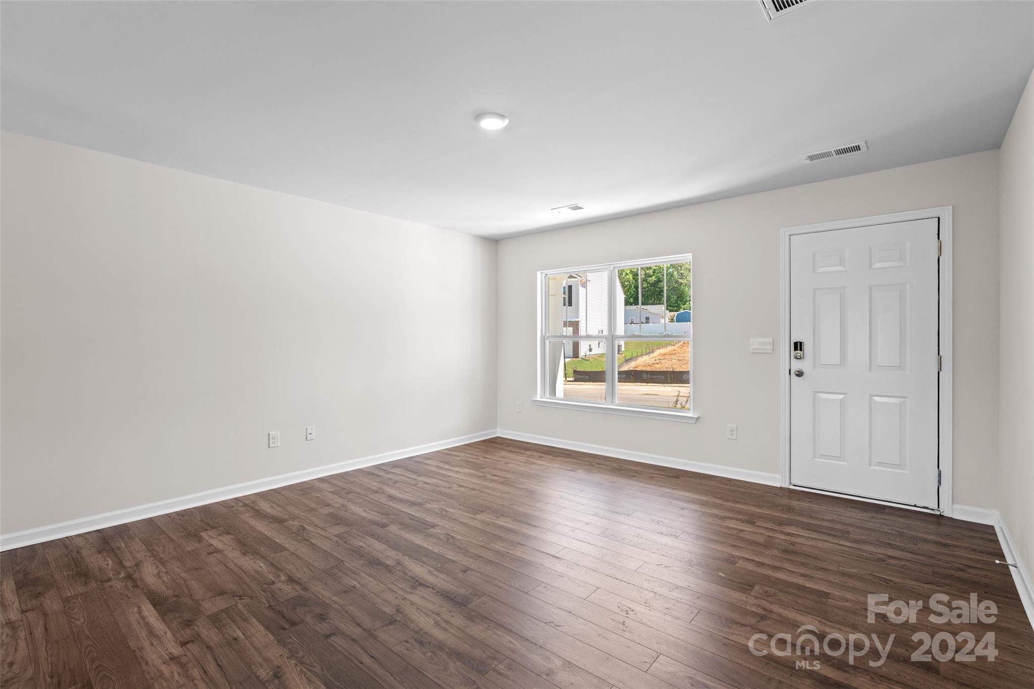 100 Callie River Clyde, NC 28721 - Photo 3 of 22 a view of an empty room with wooden floor and a window
