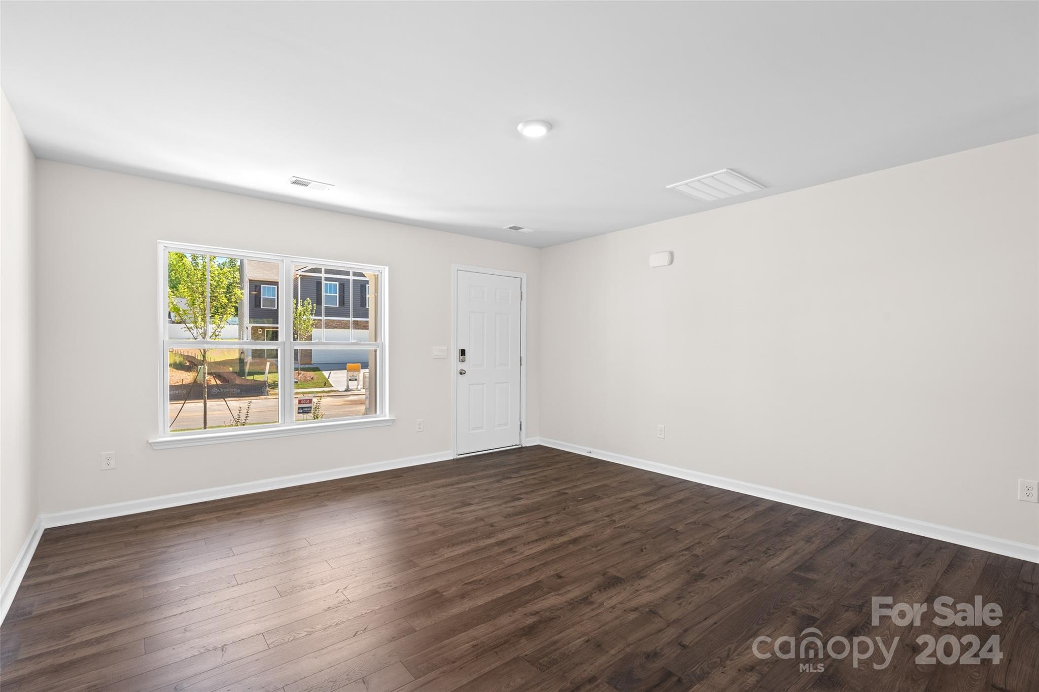 100 Callie River Clyde, NC 28721 - Photo 5 of 22 an empty room with wooden floor and windows