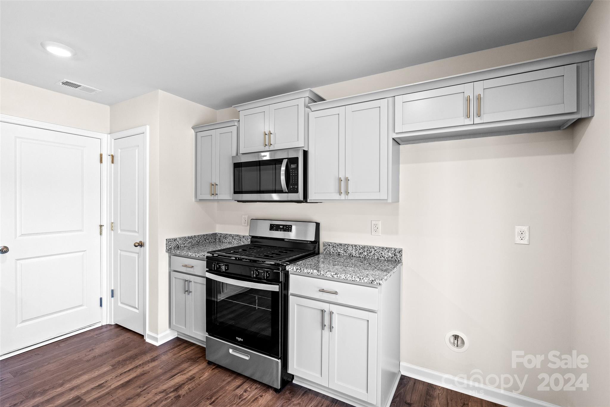 100 Callie River Clyde, NC 28721 - Photo 8 of 22 a kitchen with sink a microwave a refrigerator and cabinets