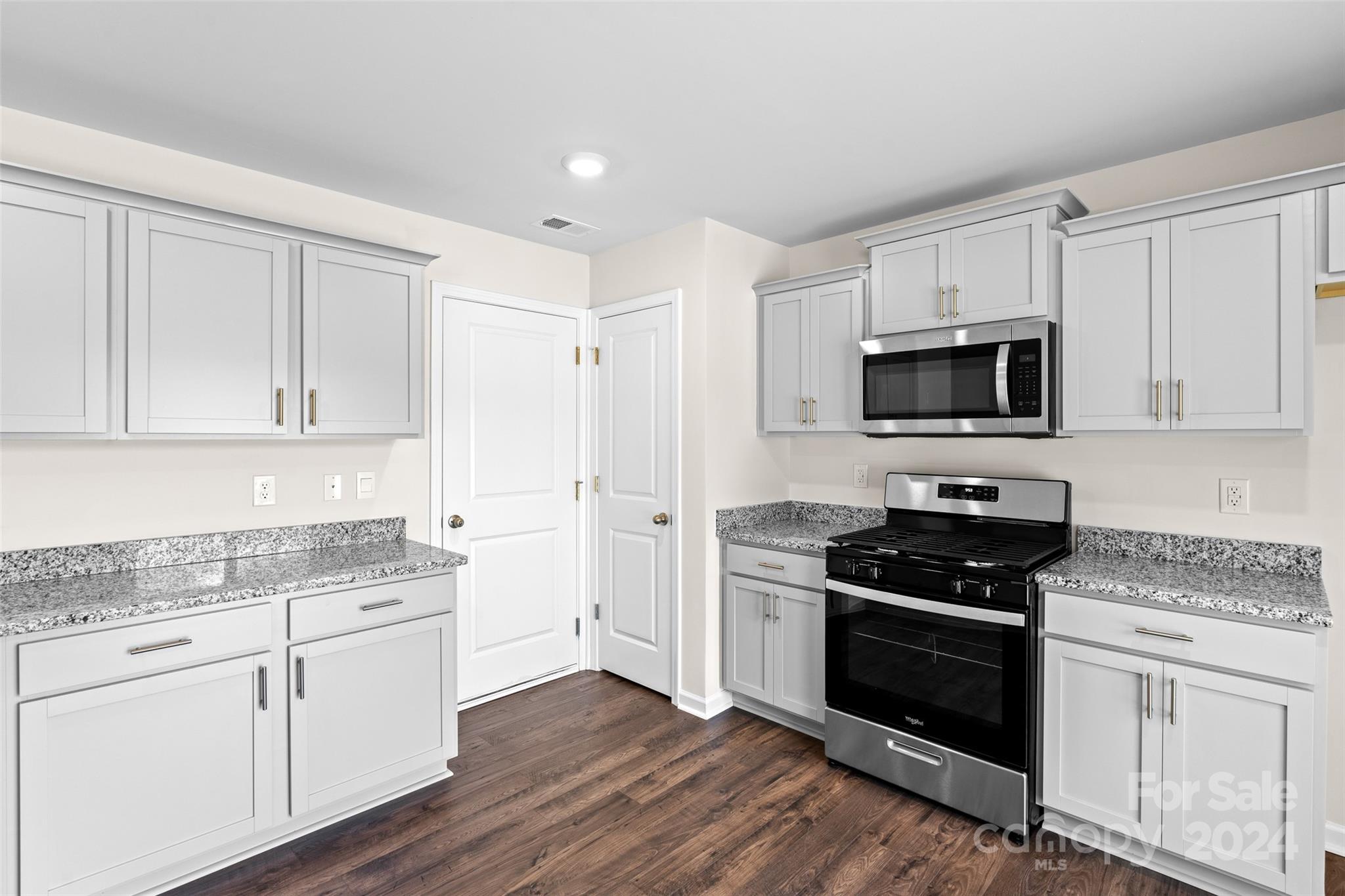 100 Callie River Clyde, NC 28721 - Photo 9 of 22 a kitchen with sink a microwave and cabinets