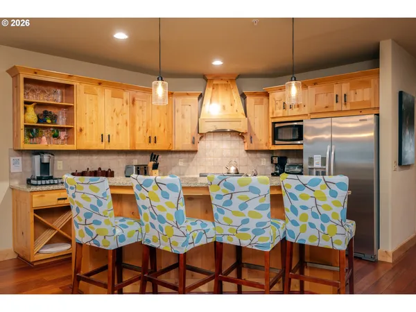 a kitchen with kitchen island dining table and chairs