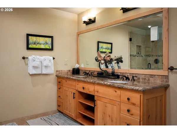 a bathroom with a sink a mirror and a shower