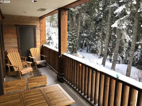 a view of balcony with wooden floor and seating