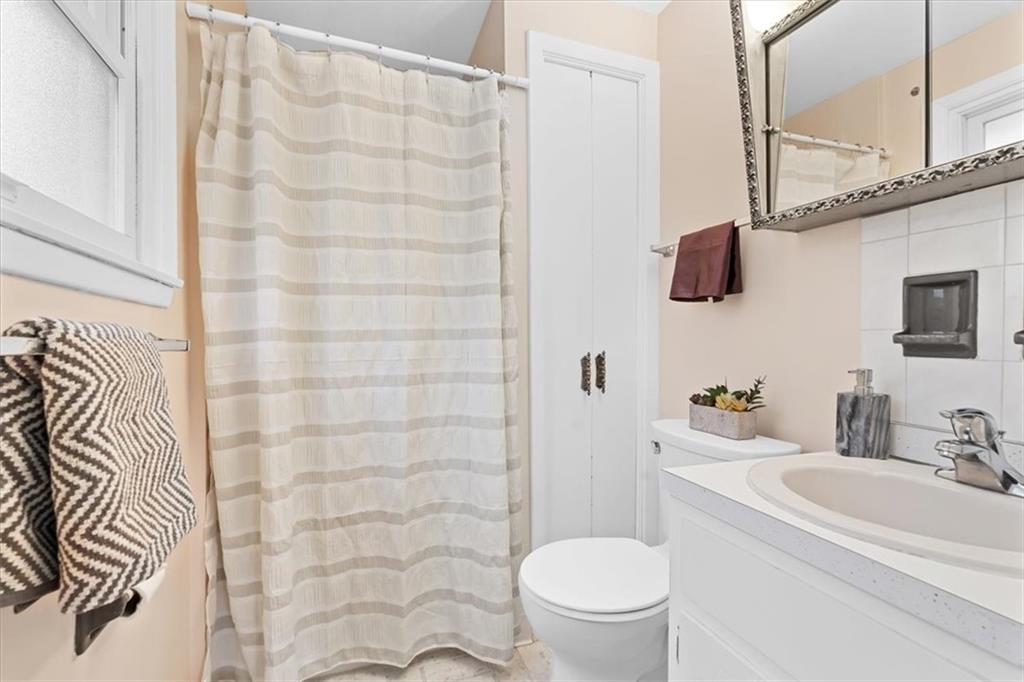 104 Dounreay Place Pittsburgh, PA 15237 - Photo 20 of 43 a bathroom with a sink a toilet and shower curtain