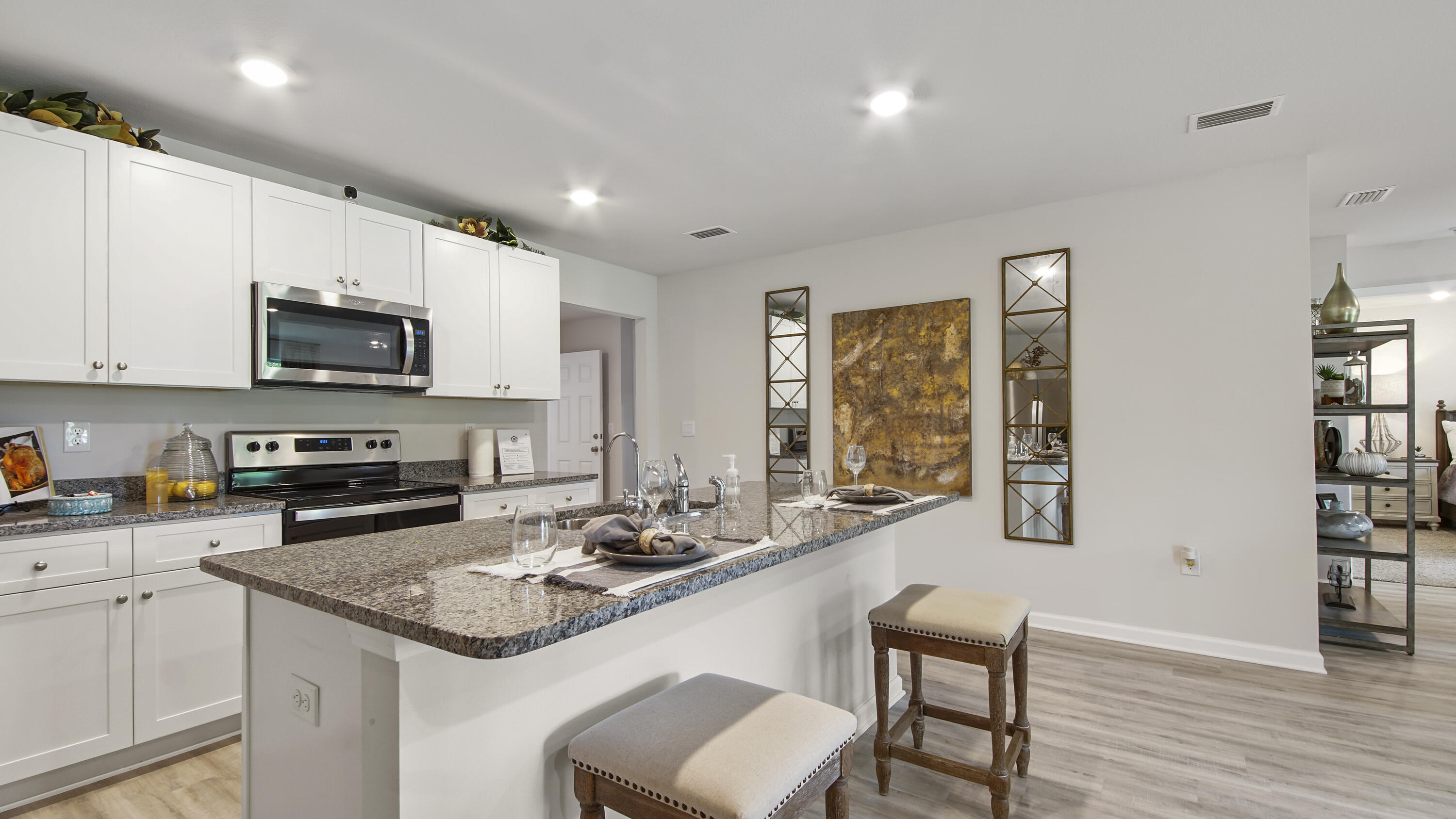 211 Gray Owl Drive Freeport, FL 32439 - Photo 8 of 35 a kitchen with stainless steel appliances granite countertop a stove a sink a microwave a dining table and chairs