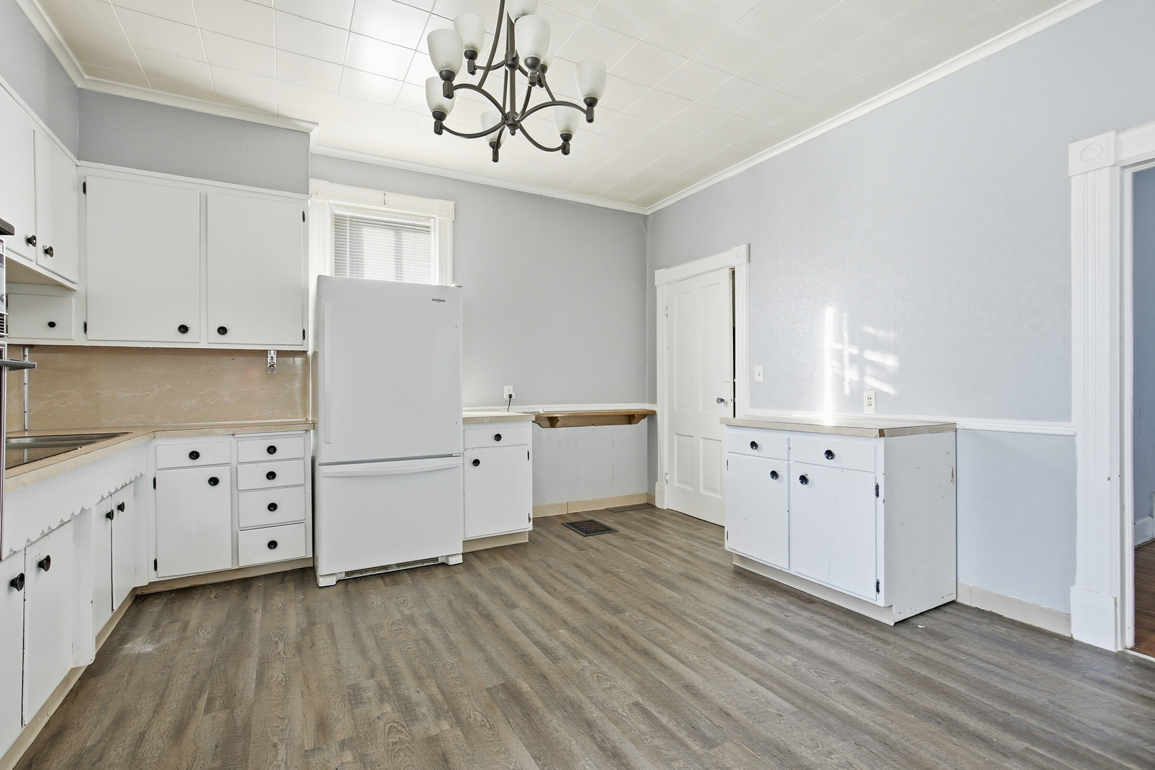 2115 West 4th Street Davenport, IA 52802 - Photo 19 of 24 a kitchen with cabinets wooden floor and a window