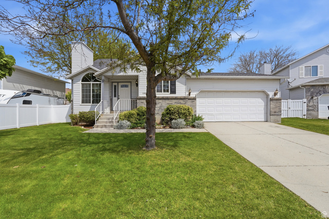 1183 East 2300th Street North Layton, UT 84040 - Photo 1 of 1 View from front of property with a chimney, a garage, driveway, and a gate