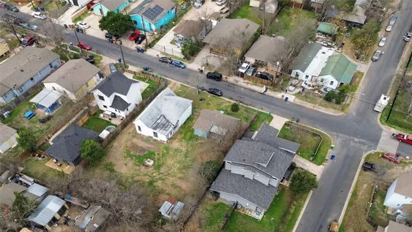 an aerial view of residential houses with outdoor space and parking