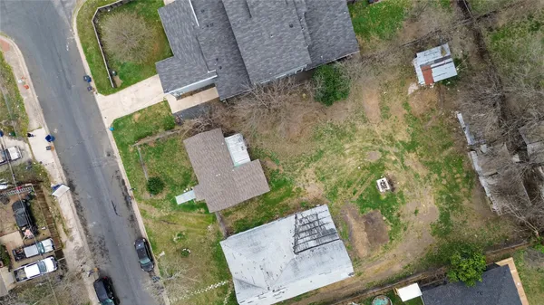 an aerial view of residential houses with outdoor space and street view