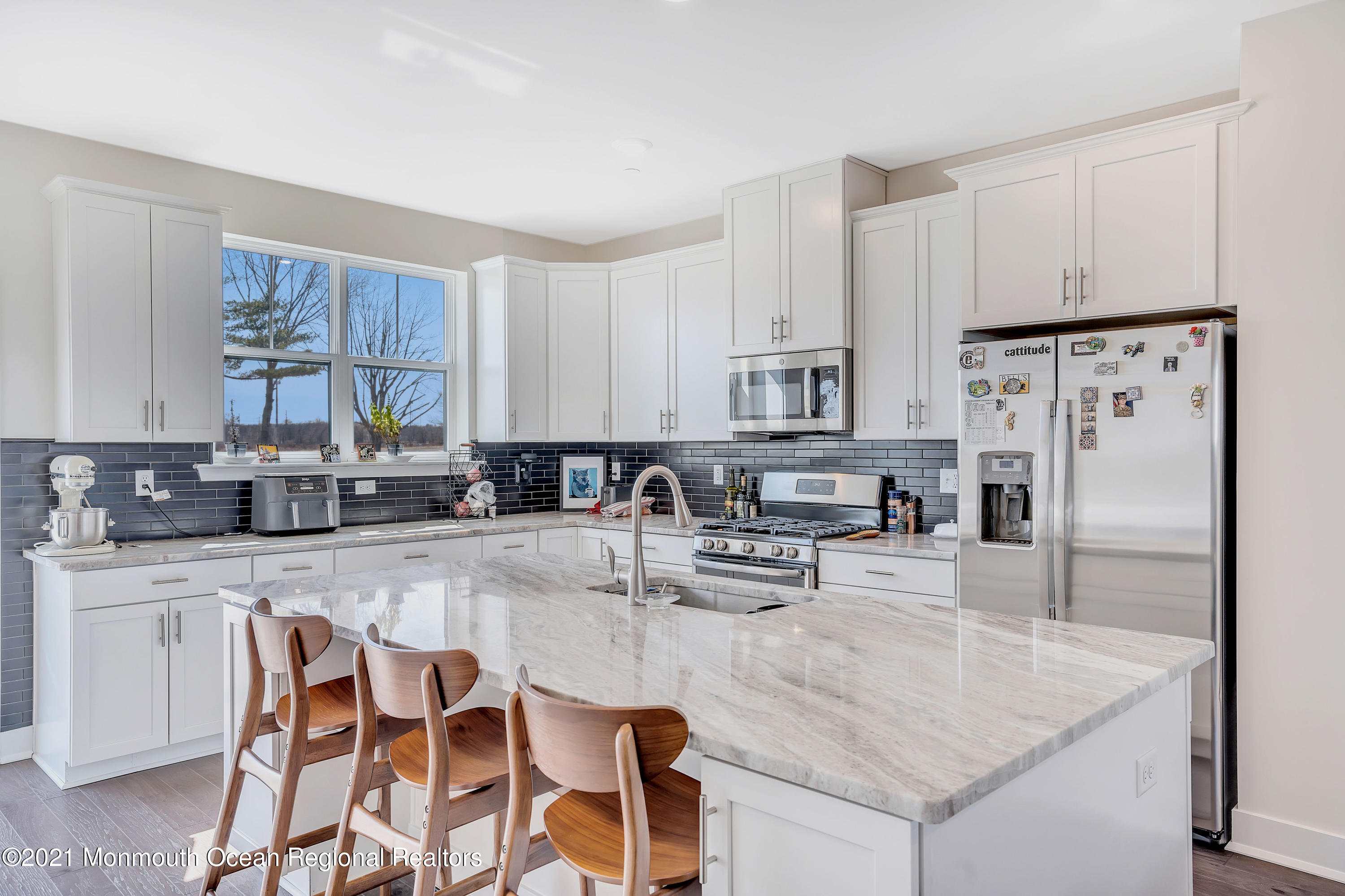 26 Kelly Way Tinton Falls, NJ 07724 - Photo 11 of 34 a kitchen with stainless steel appliances granite countertop a table chairs and a refrigerator