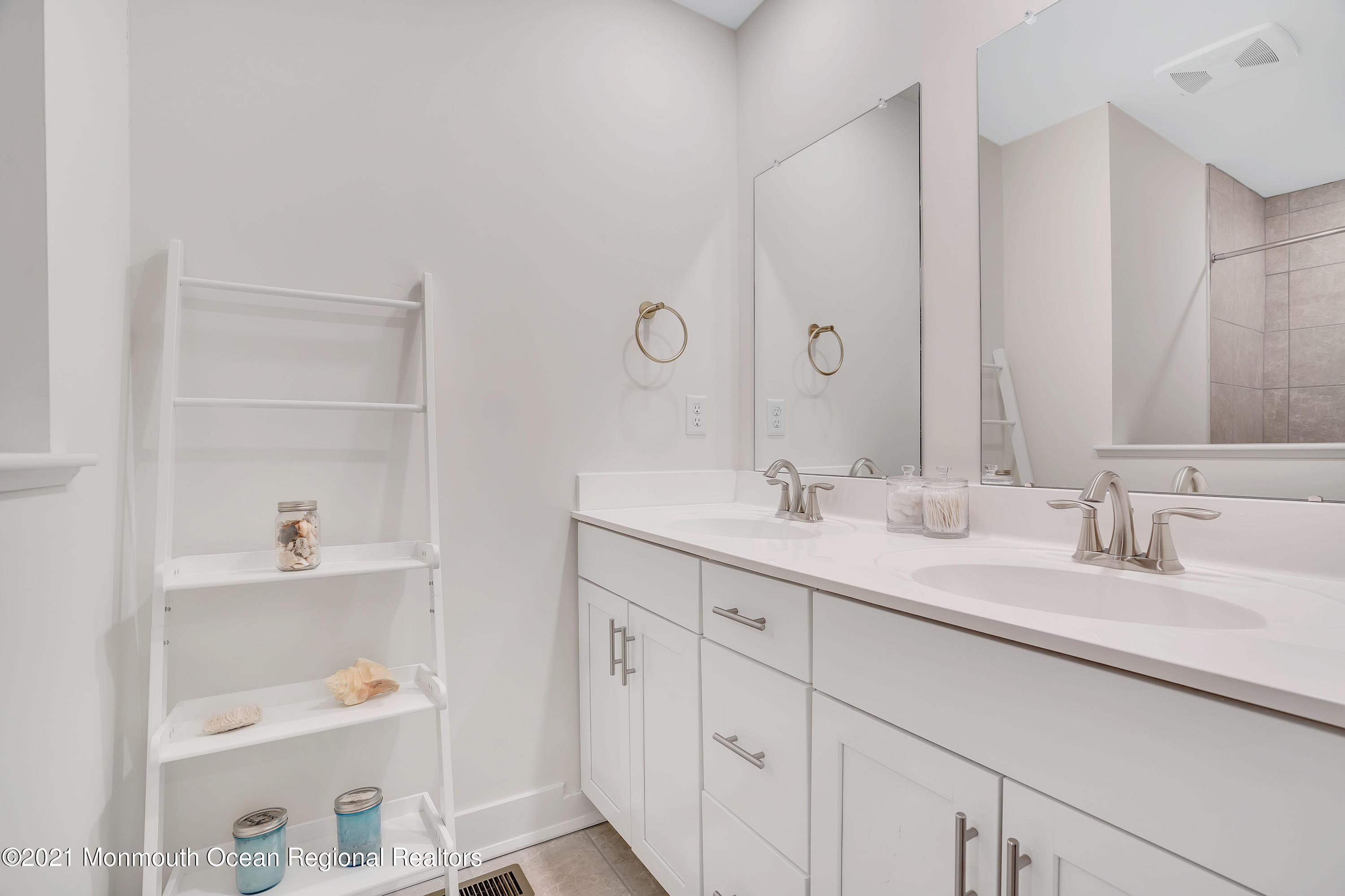 26 Kelly Way Tinton Falls, NJ 07724 - Photo 23 of 34 a bathroom with a sink and a mirror